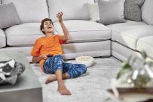 boy sitting by couch after carpet cleaning in the woodlands tx