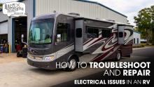 A Class A Motorhome Parked Outside of a Workshop for Electrical Works