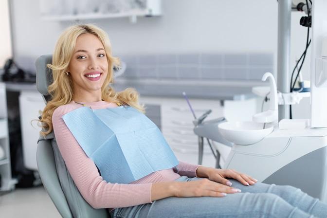 blonde-young-woman-patient-smiling-in-dental-office