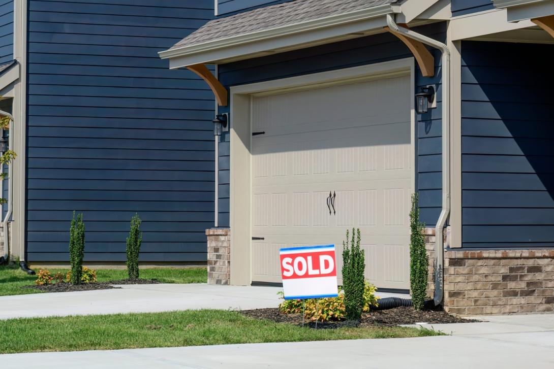 newly constructed condo with a sold sign in front
